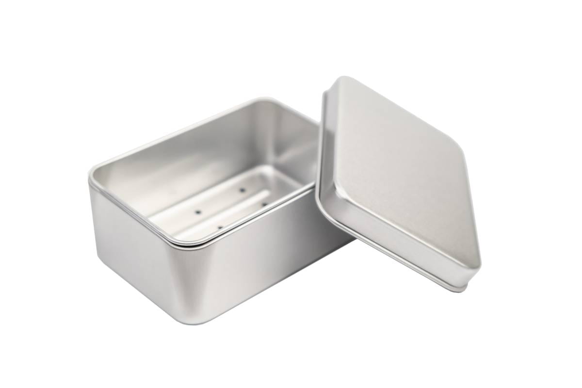Geöffnete rechteckige Seifendose aus silberfarbenem Metall mit herausgenommener Abtropfschale und abgenommenem Stülpdeckel, auf weißem Hintergrund fotografiert.
